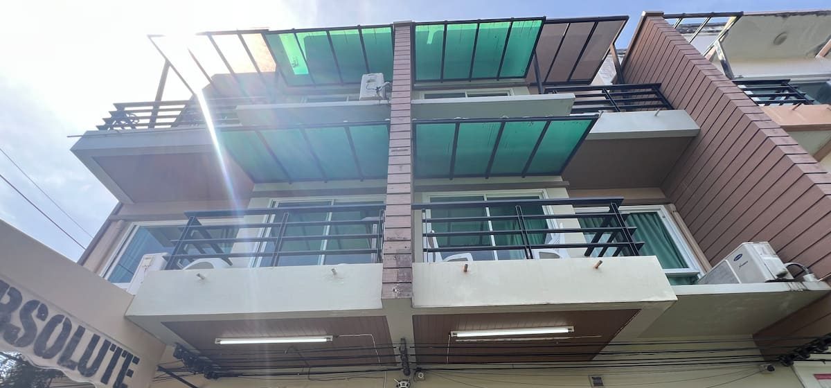 The building with green balcony awnings